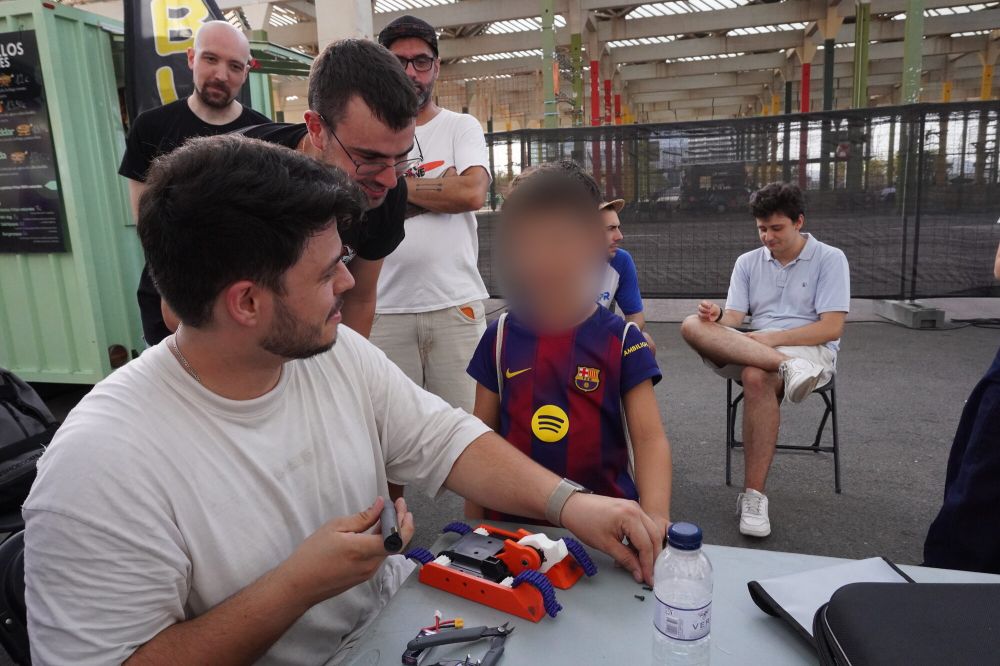 Un piloto y un niño reparan juntos un robot en la mesa
